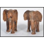 A pair of early 20th century carved wooden figurines of elephants. Measures 15 cm high.