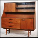 A vintage retro 20th century teak Avalon unit having sliding glass and wooden drawers. The unit