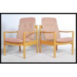 A pair of 20th century Ercol staff chairs. Light b