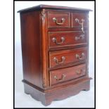 A 20th century antique style mahogany bachelors chest of drawers. Of small proportions raised on