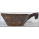A 19th century Norwegian bowl hand carved Kjenge carved wood ale cup bowl with handle to end.