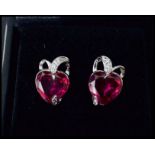 A pair of white gold and ruby and diamond earrings having heart shaped rubies. Complete in