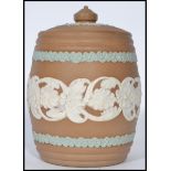 A 19th century Doulton Silicon ware pottery tobacco jar having a ribbed body and lid with finial