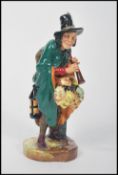 A Royal Doulton figure entitled  ' The Mask Seller ' model number HN2103. Early printed green
