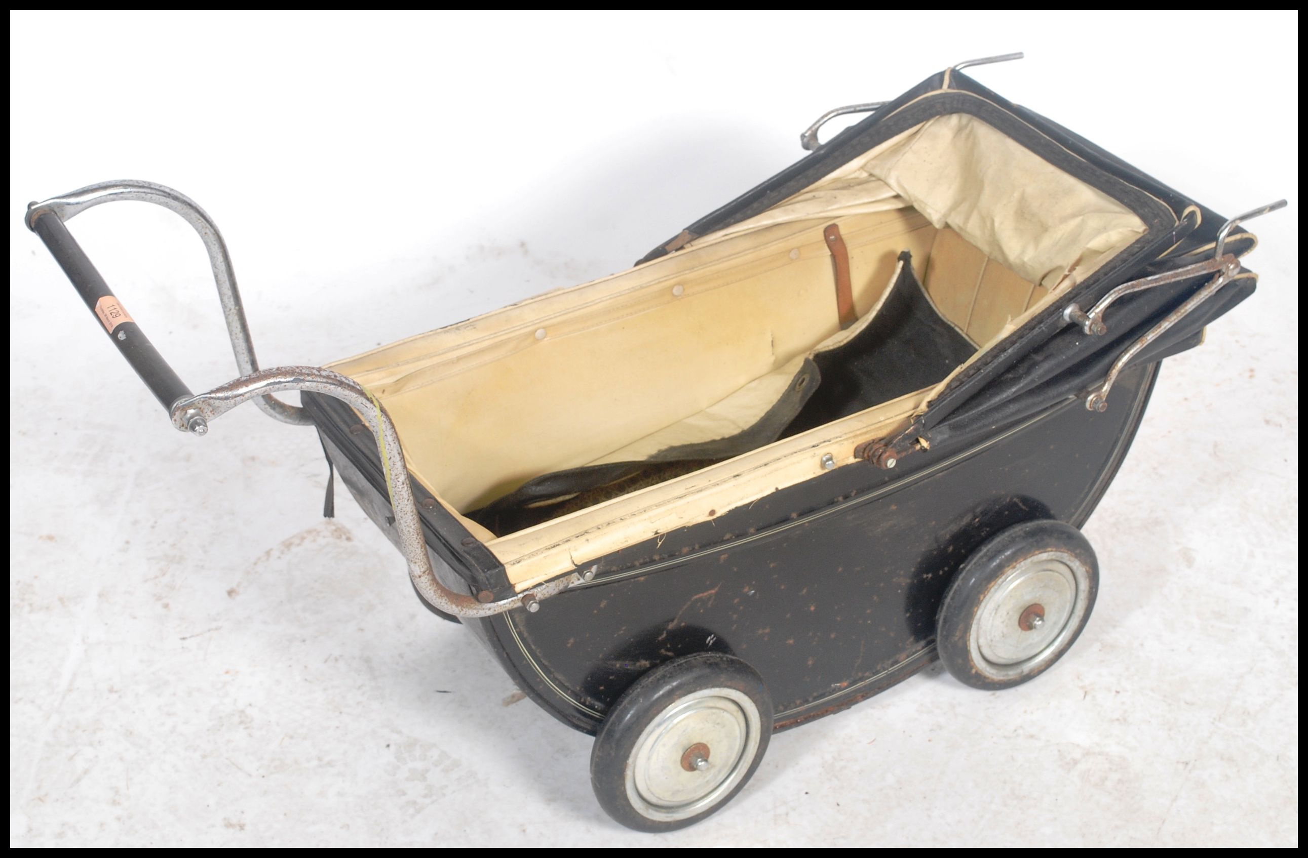 A vintage 20th century childs enamel painted pram in black with the original spoked wheels. The - Image 3 of 4