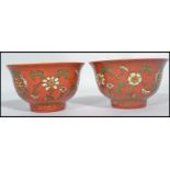 A pair of 19th century Chinese porcelain prayer bowls having red grounds decorated with medallions