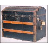 A 19th century Victorian dome top trunk having hinged top being ebonised canvas and wooden bound