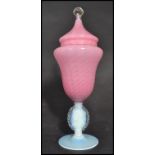 A 20th century Venetian glass lidded vase having an opalescent circular foot with pink swirl body