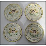 A collection of 4 believed 19th century Faience ware plates decorated with blue and yellow geometric