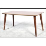 Portwood - A 1970's retro teak effect coffee table having a slight lipped ridge and raised on