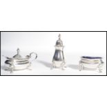 A silver hallmarked silver condiment set comprising of a pepperpot , mustard and salt pots with