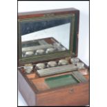 A 19th century Victorian mahogany cased travelling vanity nessasaire. The hinged lid opening to