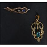 A 9ct gold (unmarked) scrolled brooch having a blue stone with a pearl weighs 2.9 grams along with a