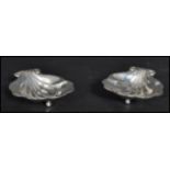 A pair of 20th century Canadian sterling silver butter dishes in the form of clam shells raised on