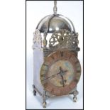 An early 20th century silver plated Buren lantern clock having a Roman numeral chapter ring with