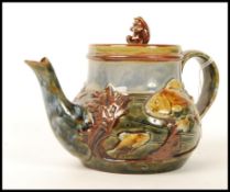 A Royal Doulton stoneware teapot and cover, the design attributed to George Tinworth, the body