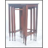 An early 20th century Edwardian inlaid mahogany trio nest of tables raised on squared legs and