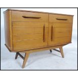 A retro mid century sideboard having short drawers over twin door cupboard and raised on tapering