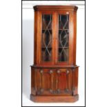 A good quality mahogany Georgian revival corner cabinet raised on plinth base with cupboard having a