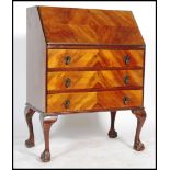 A vintage 20th century mahogany bureau, fall front with fully appointed interior together with a