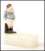 A Royal Doulton figurine pipe holder having a figure of Fat Boy on an onxy base. The base signed