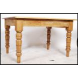 A 20th century pine dining table having a square top and rounded edges, the frieze having a single