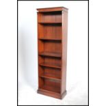 A 20th century Georgian revival open front tall mahogany bookcase, fitted with a series of