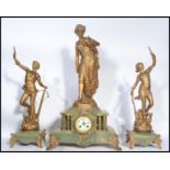 A 19th century clock and garniture set raised on green marble bases with ormolu detailing. The