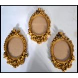 A group of three 20th century gilt plaster moulded picture frames. The glazed frames moulded in