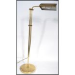 A vintage 20th century floor standing anglepoise brass bankers lamp having an adjustable shade