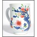 An 18th century Chinese porcelain tankard having hand painted poly - chrome decoration depicting