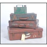 A stack of vintage 20th century suitcases together with a mid century fuel / petrol can.
