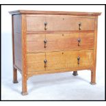 An early 20th century Edwardian Arts & Crafts solid  oak chest of drawers hjaving three long drawers