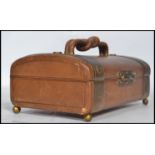 A vintage mid 20th century leather and brass bound jewellery box / casket, hinged lid raised on ball