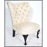 A 20th century  ebonised balloon back Victorian style nursing chair with button back upholstery