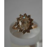 A hallmarked 9ct gold cluster ring set with a central white stone surrounded by a white stone