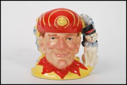 A Royal Doulton double sided character jug depicting Punch and Judy D6946 , handle modelled as a
