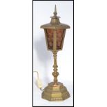 A vintage early 20th century brass lantern raised on a stepped octagonal base with knopped stem. The
