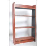 An early 20th century pine waterfall open bookcase fitted with a series of graduating fixed shelves.