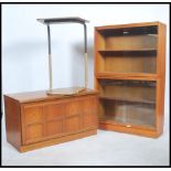 A vintage 20th century teak wood lawyers stacking bookcase cabinet of sectional form with glass