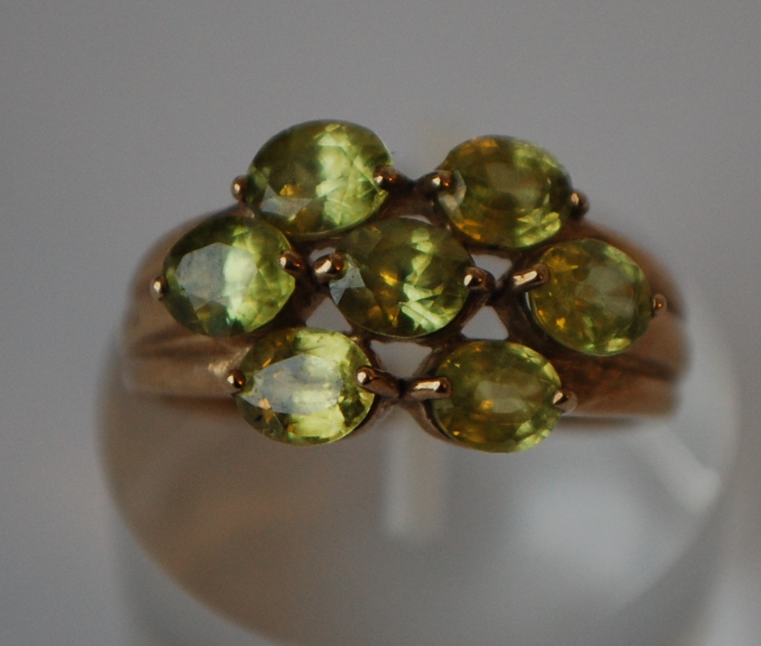 A hallmarked 9ct gold cluster ring set with peridot. Hallmarked Birmingham. Size N. Weight 3.3g