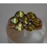 A hallmarked 9ct gold cluster ring set with peridot. Hallmarked Birmingham. Size N. Weight 3.3g