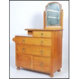 A 1930's Waring & Gillows solid oak and marble dressing table / chest of drawers having an