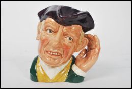 A Royal Doulton character jug entitled 'ard of 'earing D6588 , handle modelled as a hand surrounding