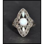 A sterling silver art deco style ring having opals and marcasites. Size Q weighs 7 grams.