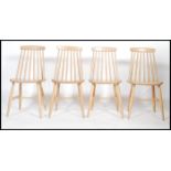 A set of four 20th century beech wood  hoop back dining chairs in the manner of Ercol. Measures