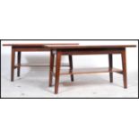 A pair of retro 20th century plank topped coffee tables being two tiered made from mahogany and