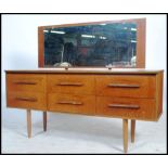 A 20th century vintage Danish style teak wood dressing table in the manner of Mogens Kolo. Raised on