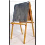 A vintage 20th century children's easel blackboard being double sided complete with twin tray's that