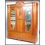 An Edwardian mahogany large double wardrobe. Raised on plinth base with twin drawers having large